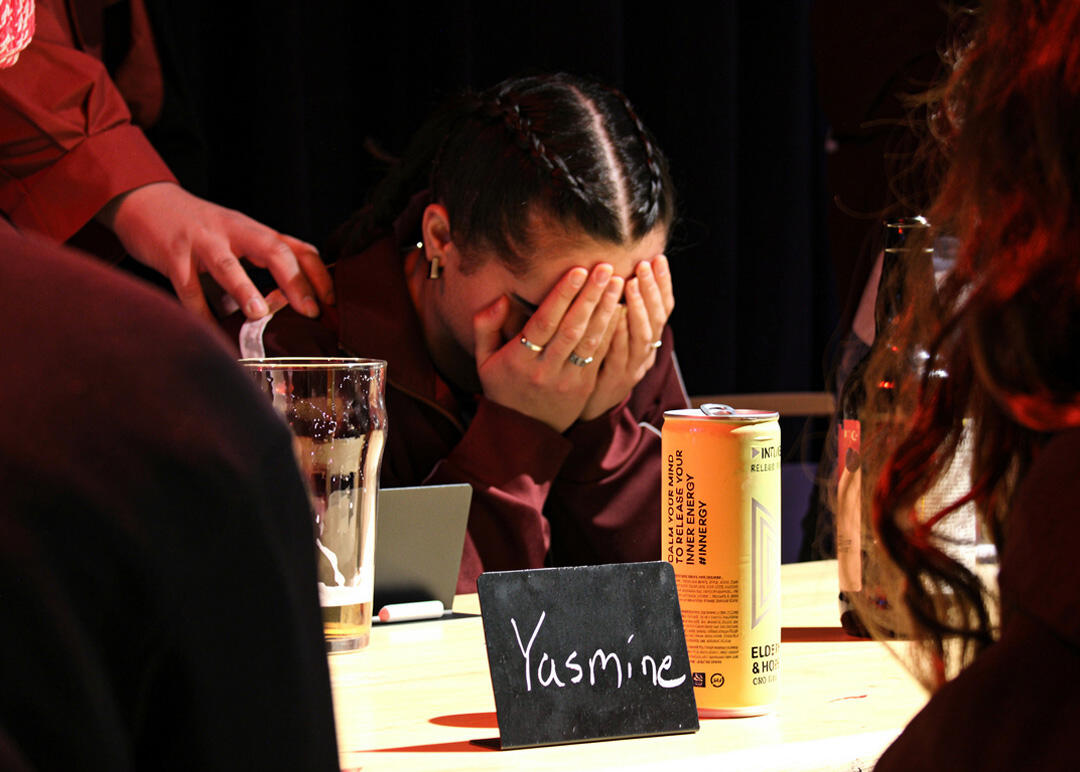 Photo of woman covering eyes as host touches her shoulder. Choosing her to be a Traitor.