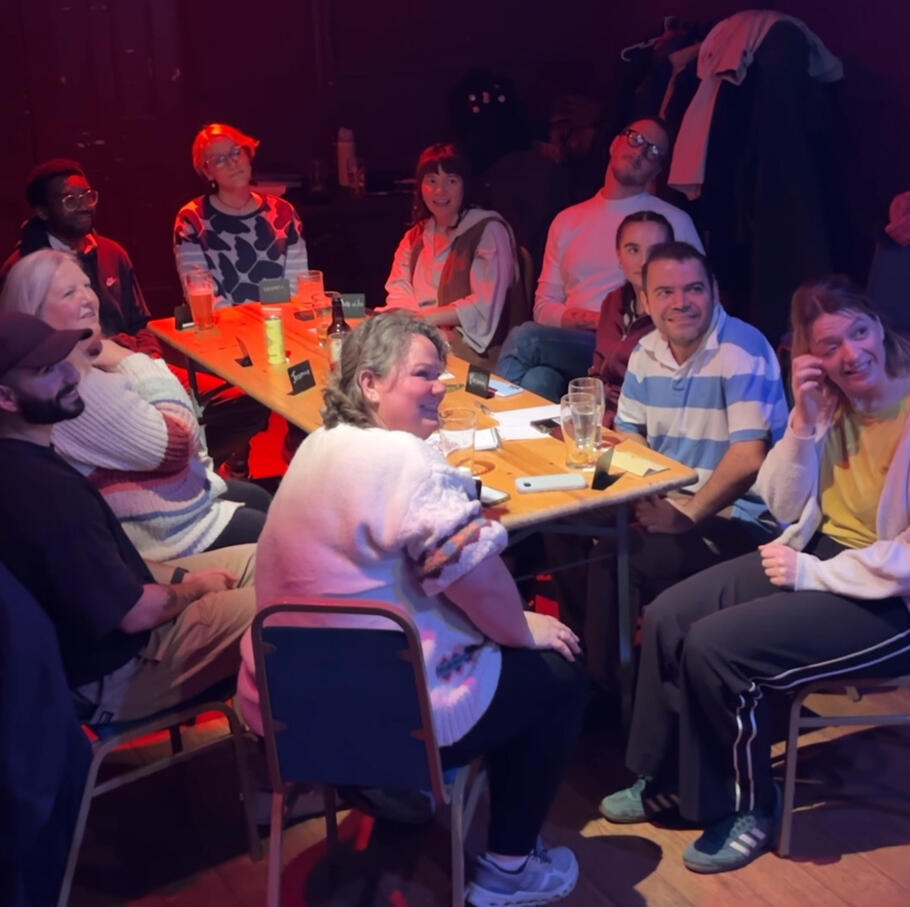 Round Table Ground of people sat around a table looking surprised